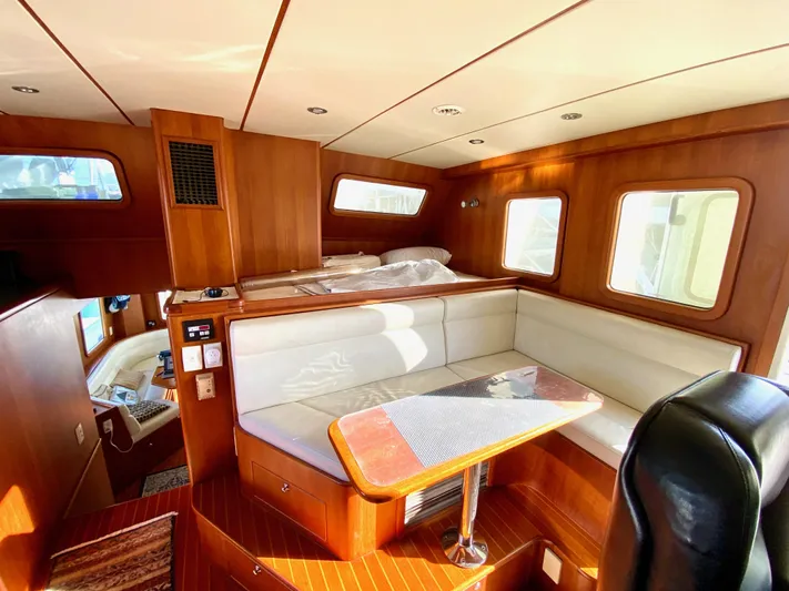 Bunyip I Yacht Photos Pics Luxurious 2002 Nordhavn 47 yacht interior with wood paneling and cozy seating area.