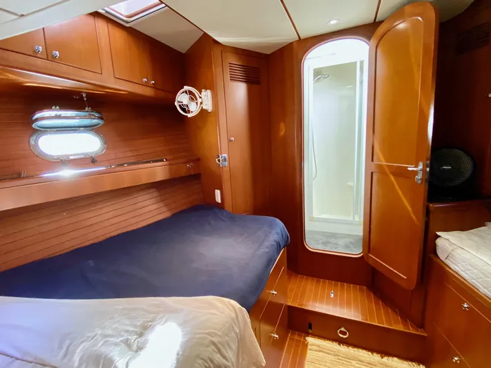 Bunyip I Yacht Photos Pics Luxurious cabin interior of 2002 Nordhavn 47 yacht with bed and ensuite bathroom.