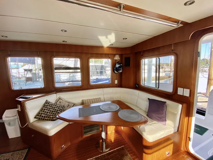 Bunyip I Yacht Photos Pics Luxurious 2002 Nordhavn 47 yacht interior with elegant wood finish and cozy seating area.