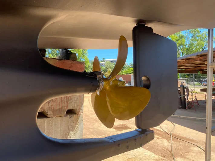 Bunyip I Yacht Photos Pics Close-up of a Nordhavn 47 (2002) boat propeller and rudder in a shipyard.
