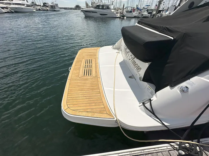 That's Amore Yacht Photos Pics 2015 Sea Ray 350 Sundancer docked, featuring a wooden swim platform.