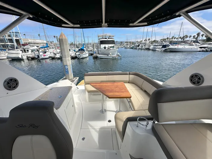 That's Amore Yacht Photos Pics 2015 Sea Ray 350 Sundancer yacht interior with seating and table, docked at marina.