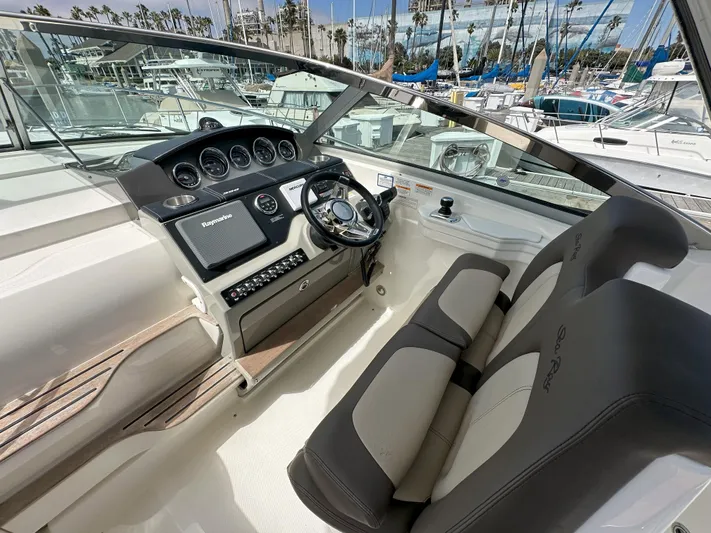 That's Amore Yacht Photos Pics 2015 Sea Ray 350 Sundancer helm with modern controls and comfortable seating at marina.