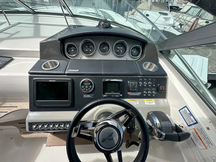 That's Amore Yacht Photos Pics Cockpit of 2015 Sea Ray 350 Sundancer with steering wheel and control panel.