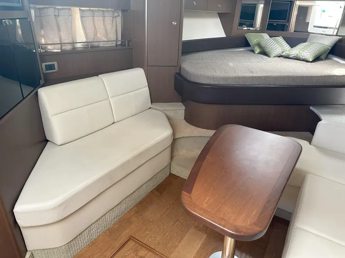 That's Amore Yacht Photos Pics Interior of 2015 Sea Ray 350 Sundancer with seating, table, and bed.