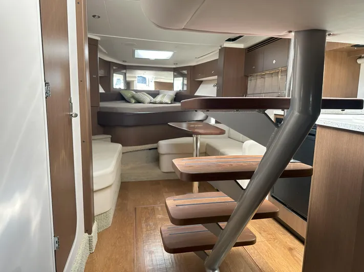 That's Amore Yacht Photos Pics Interior of 2015 Sea Ray 350 Sundancer yacht with modern wood finishes and cozy seating.
