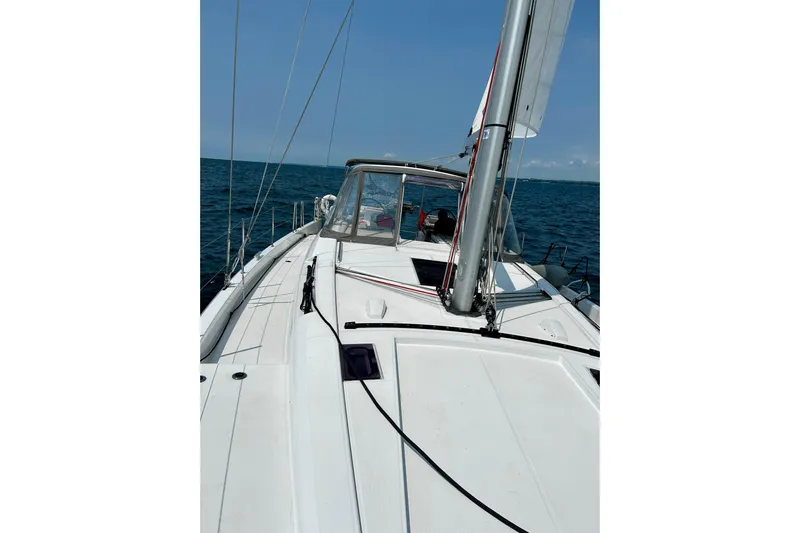 Spellbound Yacht Photos Pics 2022 Beneteau Oceanis Yacht 54 sailing on open sea, clear sky.