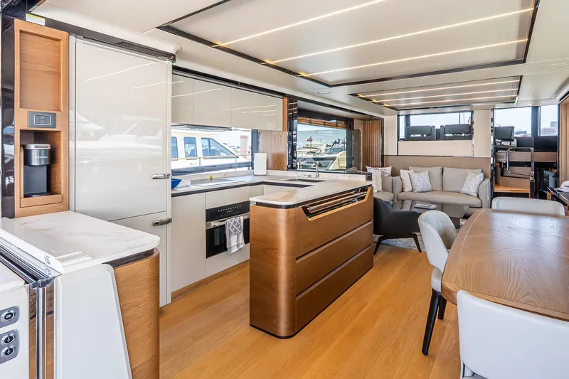 Available Now Yacht Photos Pics Luxurious interior of 2024 Absolute Navetta 68 yacht with modern kitchen and seating area.