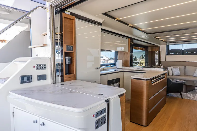 Available Now Yacht Photos Pics Luxurious interior of 2024 Absolute Navetta 68 yacht with modern kitchen and seating area.