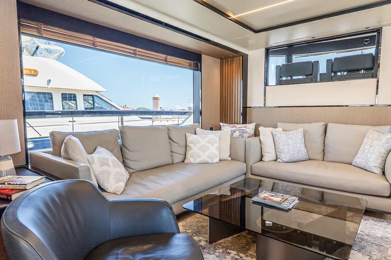 Available Now Yacht Photos Pics Luxurious interior of 2024 Absolute Navetta 68 yacht with elegant seating and large windows.