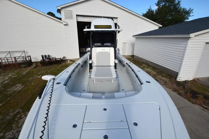 Carolina Bluewater Yacht Photos Pics 2024 Costa Custom Boats 264HC in a driveway, showcasing sleek design and spacious deck.