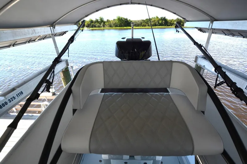 Carolina Bluewater Yacht Photos Pics 2024 Costa Custom Boats 264HC interior with cushioned seating, under canopy, overlooking water.