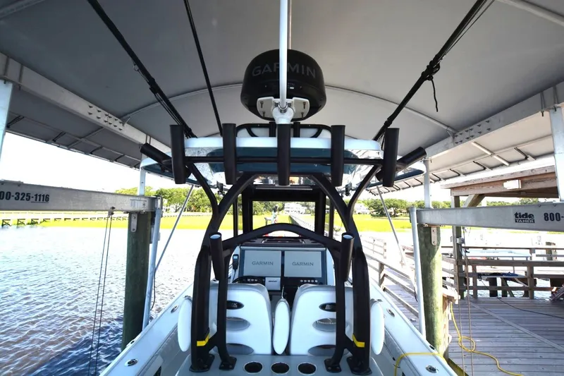 Carolina Bluewater Yacht Photos Pics 2024 Costa Custom Boats 264HC under canopy, featuring Garmin electronics and sleek design.