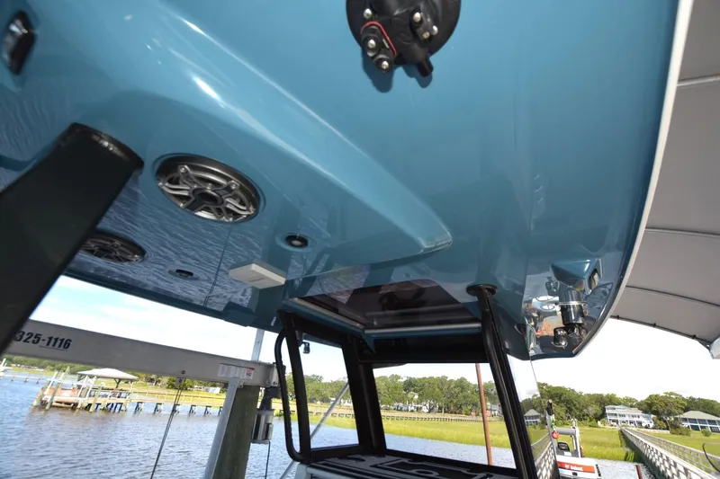 Carolina Bluewater Yacht Photos Pics 2024 Costa Custom Boats 264HC, blue hull, docked with visible speakers and equipment.