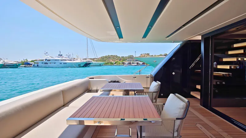 Eight44 Yacht Photos Pics Luxurious 2025 Sanlorenzo SL90A yacht deck with elegant seating and scenic marina view.
