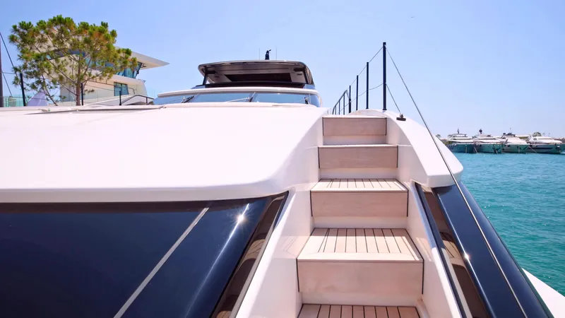 Eight44 Yacht Photos Pics 2025 Sanlorenzo SL90A yacht with sleek design and wooden steps, docked by the sea.