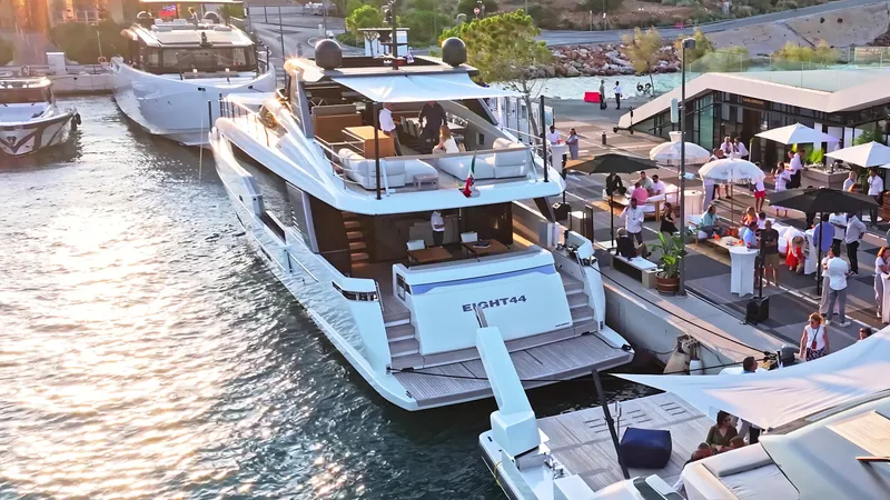 Eight44 Yacht Photos Pics Luxurious 2025 Sanlorenzo SL90A yacht docked at a lively marina event.