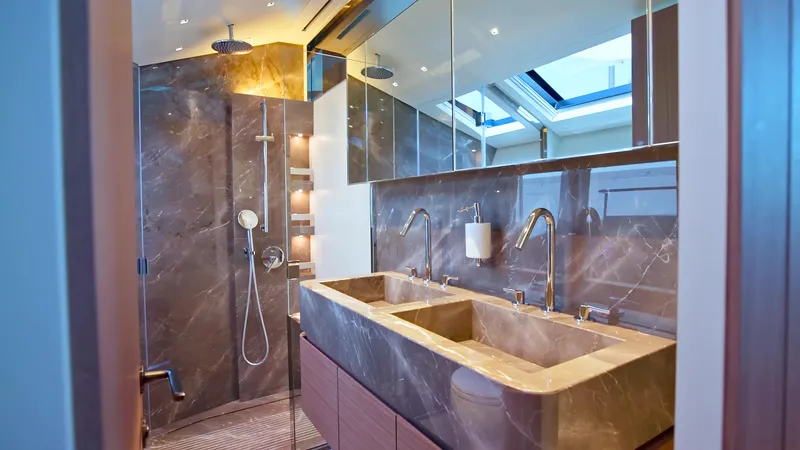 Eight44 Yacht Photos Pics Luxurious bathroom in 2025 Sanlorenzo SL90A yacht with dual sinks and modern shower.