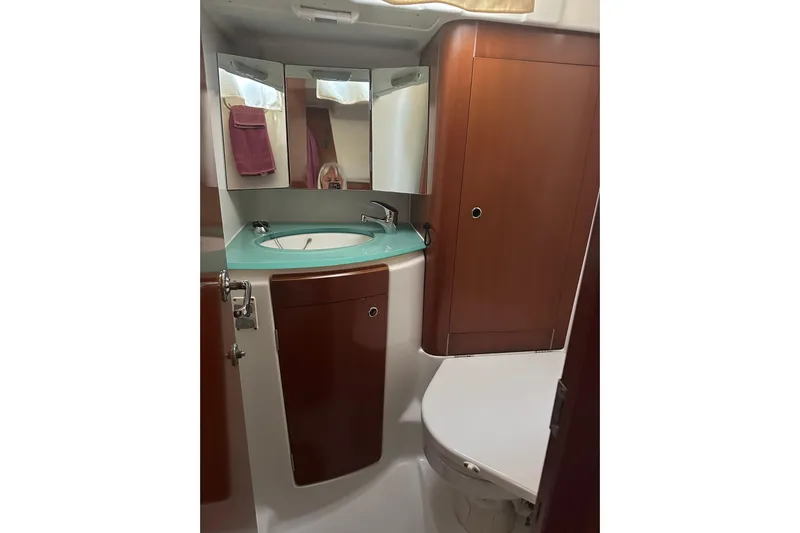  Yacht Photos Pics Bathroom interior of 2006 Beneteau Oceanis 523 yacht with wooden cabinetry and modern fixtures.