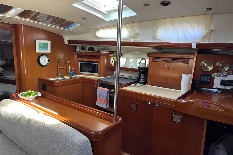  Yacht Photos Pics Interior of 2006 Beneteau Oceanis 523 yacht with kitchen and dining area.