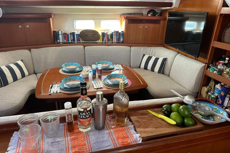  Yacht Photos Pics Interior of 2006 Beneteau Oceanis 523 yacht with dining setup and bar area.