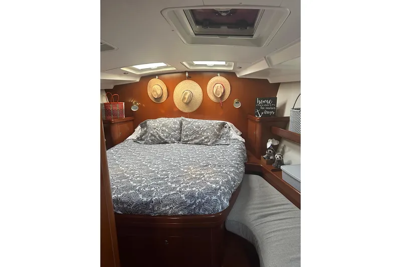  Yacht Photos Pics Cozy cabin interior of 2006 Beneteau Oceanis 523 sailboat with decorative elements.
