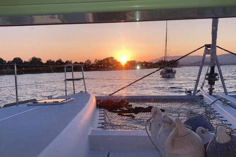 St Andrews Yacht Photos Pics Lagoon 450 F Owners Version sailing at sunset, 2014 model, tranquil sea view.