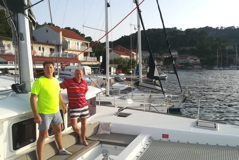 St Andrews Yacht Photos Pics Two people on a 2014 Lagoon 450 F Owners Version catamaran docked at a marina.