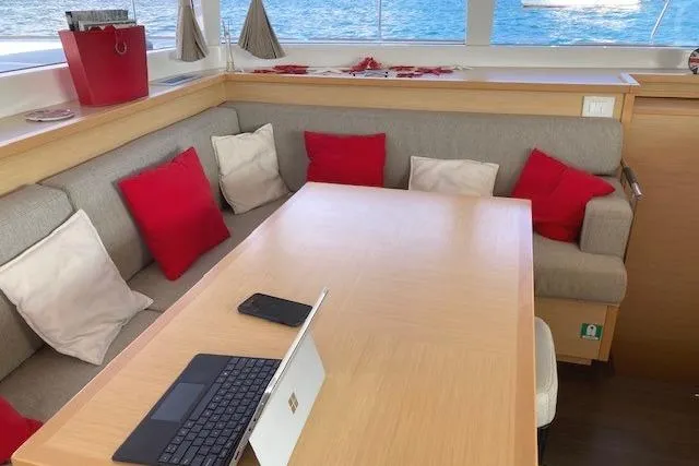 St Andrews Yacht Photos Pics Cozy interior of 2014 Lagoon 450 F Owners Version with red and white cushions.