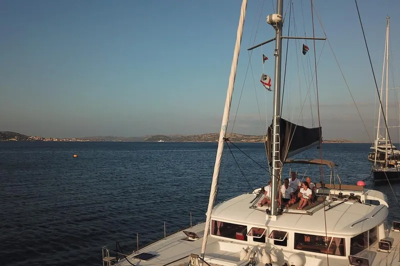 St Andrews Yacht Photos Pics 2014 Lagoon 450 F Owners Version catamaran sailing on calm sea with people on deck.