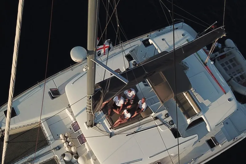 St Andrews Yacht Photos Pics Aerial view of 2014 Lagoon 450 F Owners Version catamaran with people relaxing on deck.