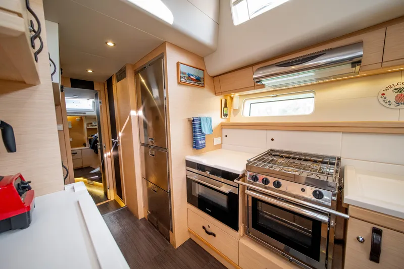 Serenity Yacht Photos Pics Luxurious kitchen interior of a 2016 Jeanneau 64 yacht with modern appliances.