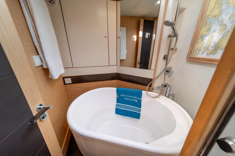 Serenity Yacht Photos Pics Luxurious bathroom in 2016 Jeanneau 64 yacht with bathtub and modern fixtures.