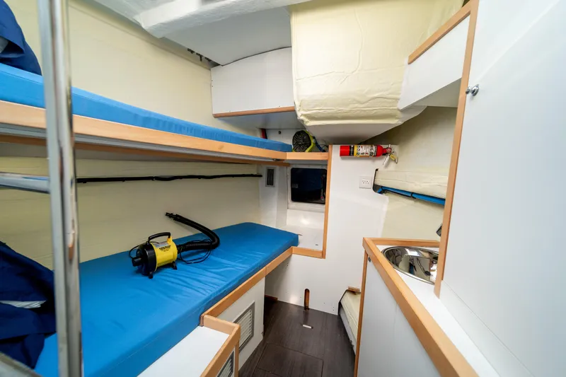 Serenity Yacht Photos Pics Interior of 2016 Jeanneau 64 yacht with bunk beds and compact kitchenette.