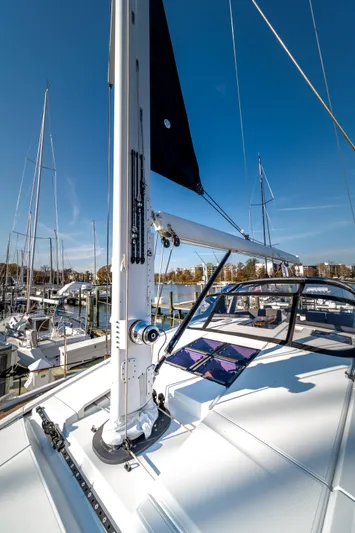 Serenity Yacht Photos Pics 2016 Jeanneau 64 sailboat deck with mast, docked in marina under clear blue sky.