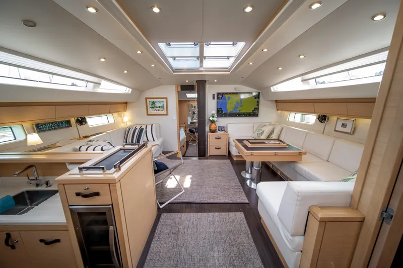 Serenity Yacht Photos Pics Luxurious interior of a 2016 Jeanneau 64 yacht with modern furnishings and ample natural light.