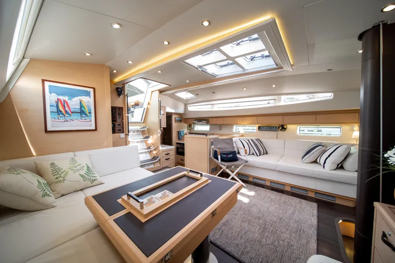 Serenity Yacht Photos Pics Luxurious interior of a 2016 Jeanneau 64 yacht with elegant seating and modern decor.