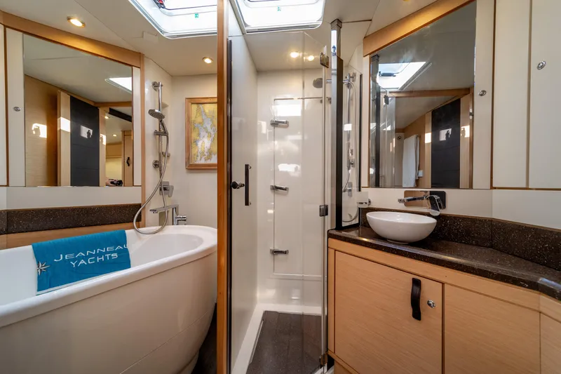 Serenity Yacht Photos Pics Luxurious bathroom on a 2016 Jeanneau 64 yacht with bathtub and modern fixtures.