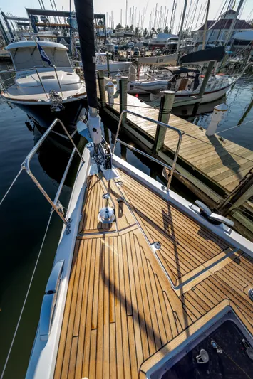 Serenity Yacht Photos Pics 2016 Jeanneau 64 yacht docked at marina, showcasing sleek wooden deck design.