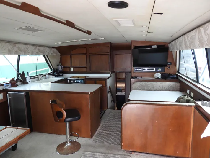  Yacht Photos Pics Interior of a 1989 Bertram Convertible yacht with wood cabinetry and modern amenities.
