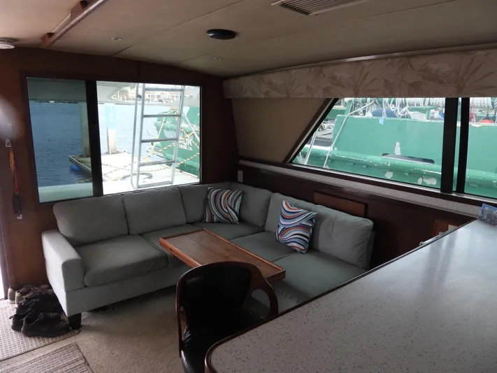  Yacht Photos Pics 1989 Bertram Convertible yacht interior with cozy seating and waterfront view.