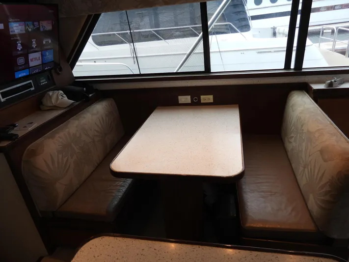  Yacht Photos Pics Interior of a 1989 Bertram Convertible yacht with a cozy dining area.
