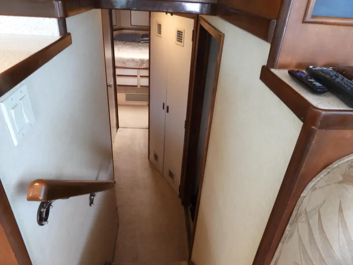  Yacht Photos Pics Interior staircase of a 1989 Bertram Convertible yacht, leading to a cozy cabin.