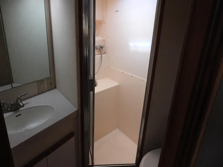 Yacht Photos Pics 1989 Bertram Convertible yacht bathroom with sink and shower.