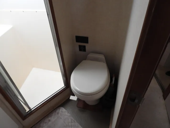  Yacht Photos Pics 1989 Bertram Convertible yacht bathroom with toilet and shower area.