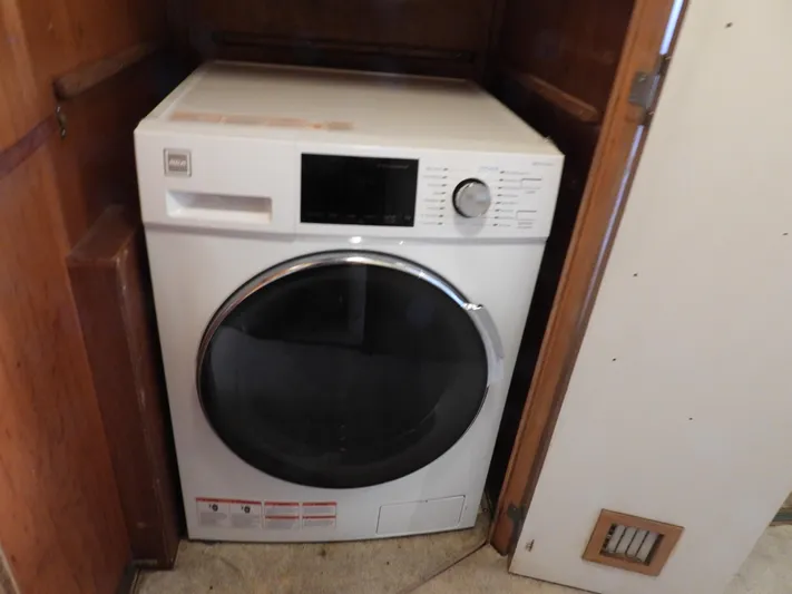  Yacht Photos Pics Front-loading washing machine in wooden cabinet on a 1989 Bertram Convertible boat.