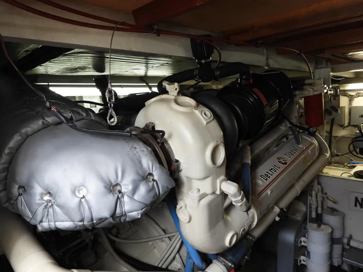  Yacht Photos Pics Engine room of a 1989 Bertram Convertible boat, showcasing a powerful marine engine.