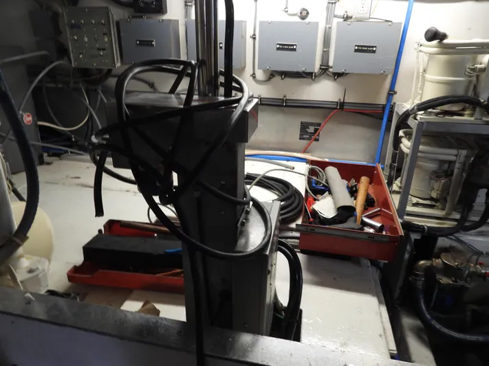  Yacht Photos Pics Engine room of a 1989 Bertram Convertible boat with tools and cables.