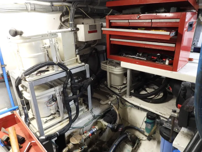  Yacht Photos Pics Engine room of a 1989 Bertram Convertible with tools and machinery.