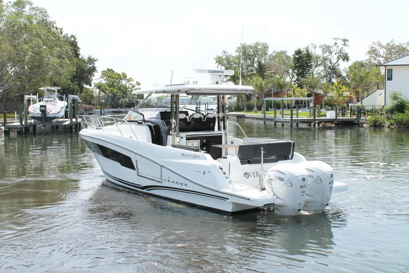 Over Exposed Yacht Photos Pics 2021 Jeanneau Leader 10.5 boat on a calm river with lush greenery.
